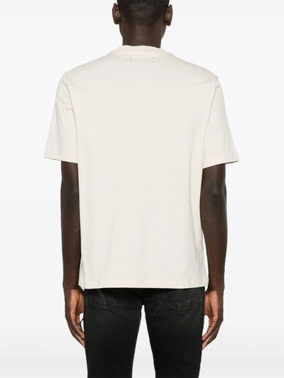 Amiri – T-Shirt mit gestaffeltem Logo-Print in Rot in Hellbeige