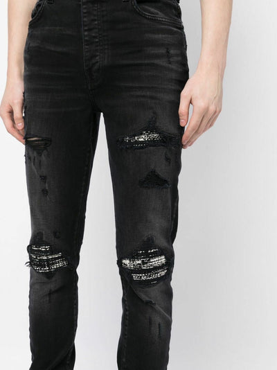 Amiri – Bouclé-MX1-Jeans mit Rissen in Schwarz