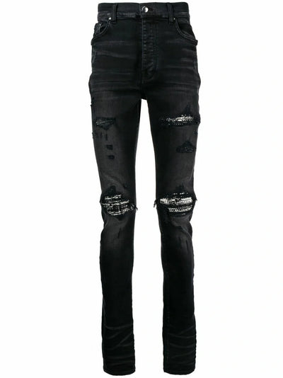 Amiri – Bouclé-MX1-Jeans mit Rissen in Schwarz