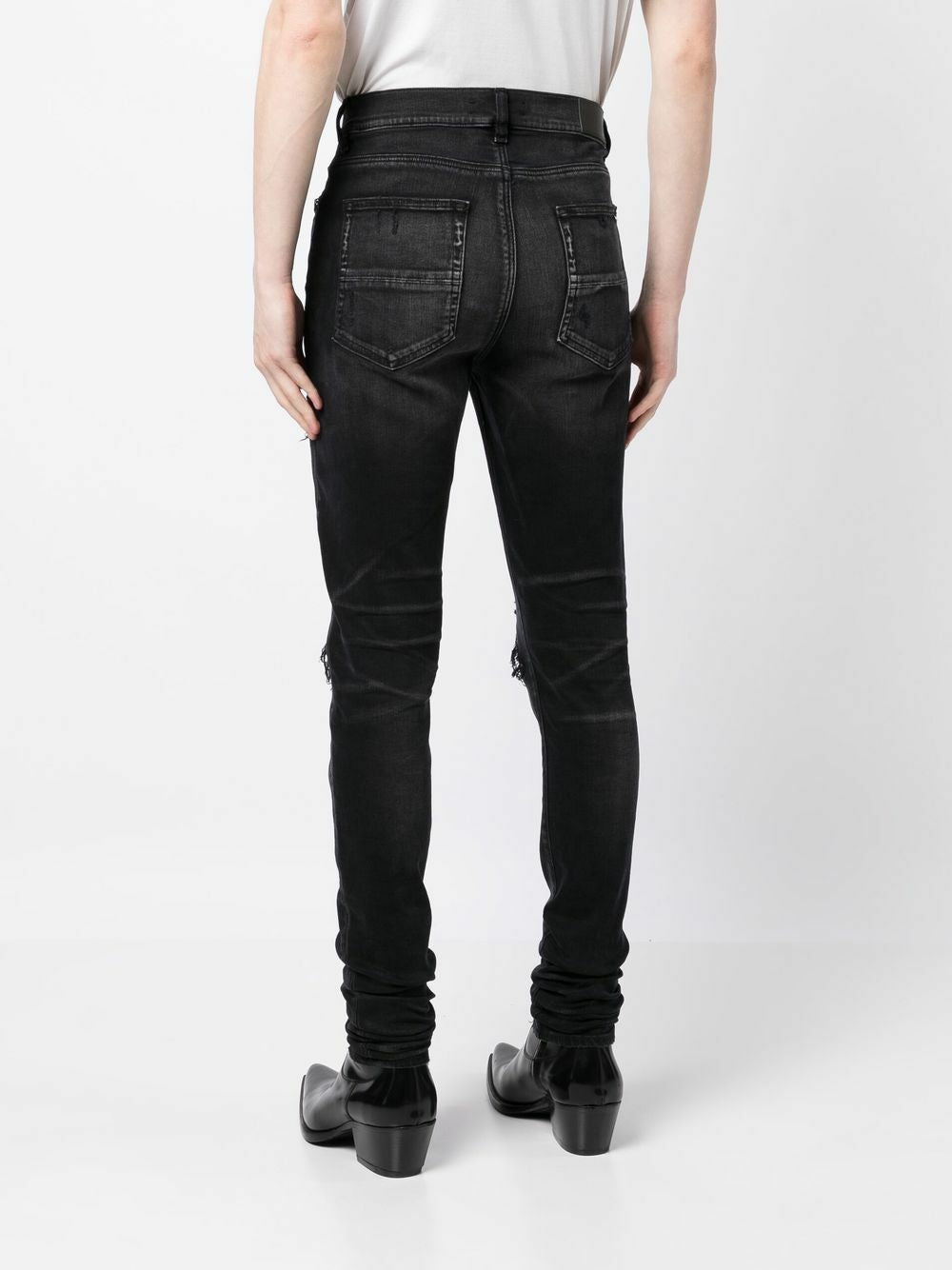 Amiri – Bouclé-MX1-Jeans mit Rissen in Schwarz
