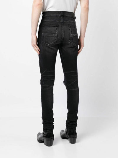 Amiri – Bouclé-MX1-Jeans mit Rissen in Schwarz