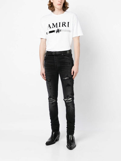 Amiri – Bouclé-MX1-Jeans mit Rissen in Schwarz
