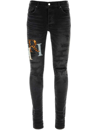 Amiri – Zerrissene Lederjeans mit versetztem Logo in Schwarz