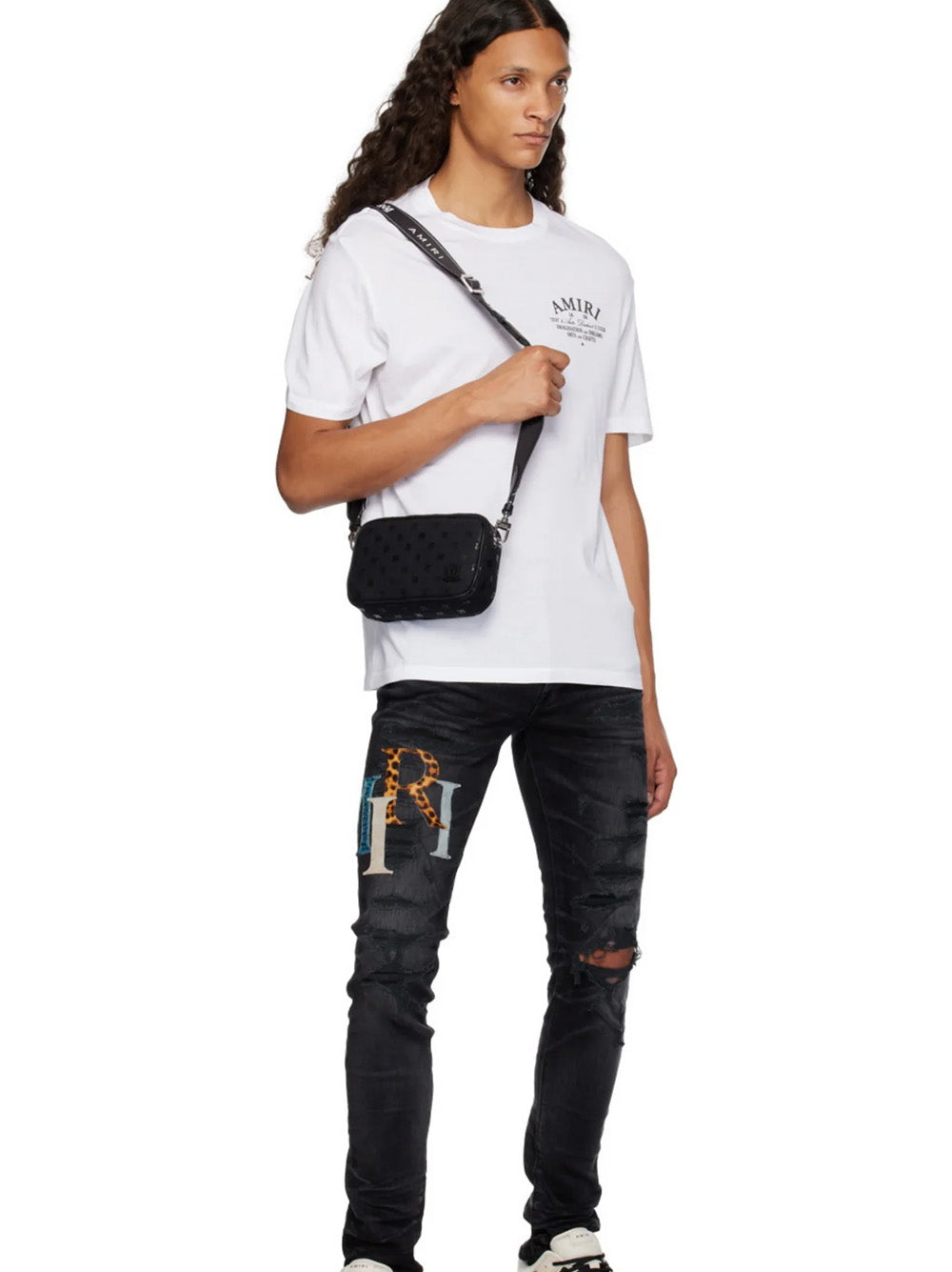 Amiri – Zerrissene Lederjeans mit versetztem Logo in Schwarz